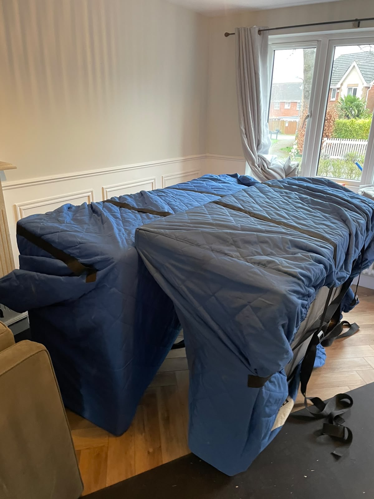 Piano wrapped in padded protective covers ready for moving